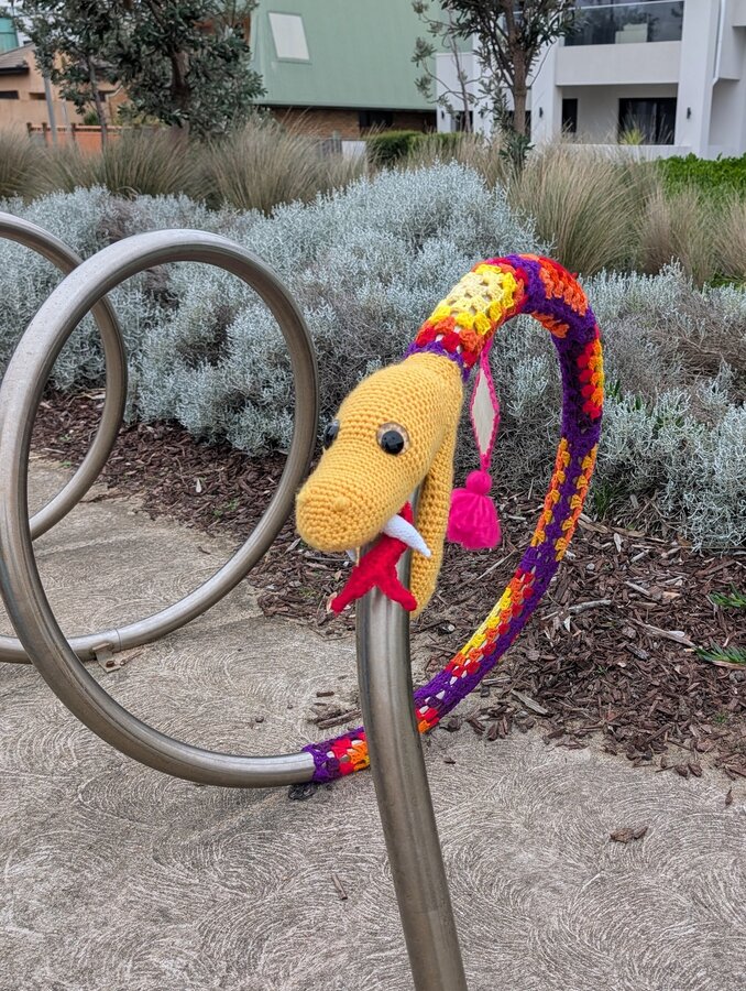 The crochet snake on the spiral bike rack